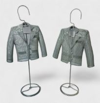 A pair of steel wire mesh jacket / blazer sculptures, possibly maquette tailor models, raised on