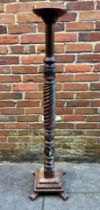 A carved and turned mahogany torchere stand, carved foliate and reeded spiral decoration, circular