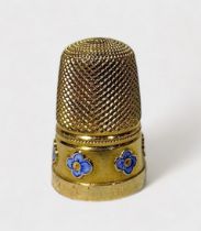An unmarked gold thimble, testing higher than 15ct, dimpled crown and diamond dimpled skirt, the