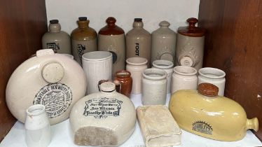 A collection of stoneware hot water bottles and bed warmers, including a Doulton & Lambeth example