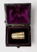 An Antique Gold Thimble, dimpled crown and skirt, the frieze with a chased bands of foliate oval