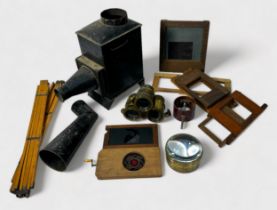 A magic lantern with a collection of assorted painted glass slides depicting portraits, landscapes