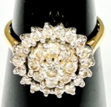 An 18ct yellow gold dress ring, claw set with round brilliant cut diamonds, in a cluster design,