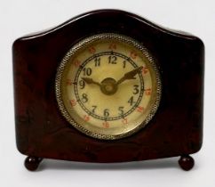 A Novelty Tape Measure modelled as a Bakelite Mantel Clock, the hands moving when the tape is