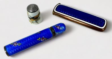 A blue guilloche enamel and floral painted white-metal needle case of cylindrical form with screw