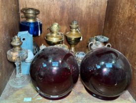 A good collection of assorted antique oil lamps, in various styles, with a number of glass