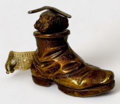 A Novelty Gilt Brass Tape Measure modelled as a Hobnail Boot with a rock and walking stick