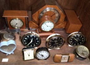 Thirteen various clocks including travel clocks, bedside alarm clocks and mantel clocks, including