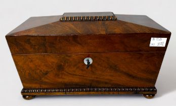 A 19th Century mahogany tea caddy of sarcophagus form, enclosing two fitted caddies, the inside of