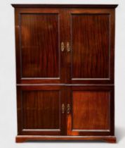 A mahogany Maple & Co three-door Compactum wardrobe in two sections, shaped cornice above the