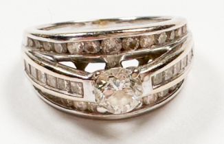 An 18ct white golds triple band ring, claw set with a single round brilliant cut diamond to the