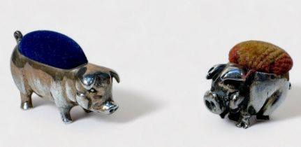 Two various sterling silver pin cushions modelled as pigs, the smaller example with rubbed Birmigham