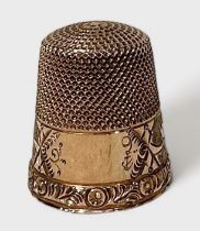 An antique gold thimble, of typical form with dimpled crown and skirt, the frieze with stylised