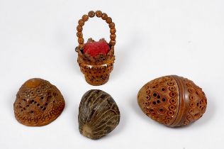 A carved and pierced Coquilla nut bucket pin cushion, a carved and pierced coquilla nut pomander,