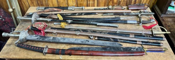 A quantity of assorted reproduction swords and training weapons, to include, Scottish basket-