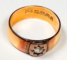 A 22ct gold wedding ring, star-set to the centre with a Victorian cut diamond, estimated diamond