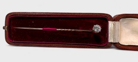 An early 20th century solitaire diamond stick pin, eight-claw set with a round brilliant cut