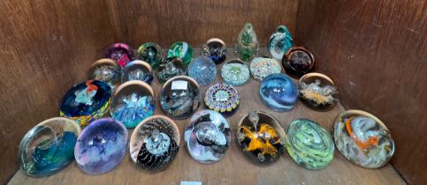 A collection of twenty-six glass paperweights including Caithness, Selkirk, Isle of Wight etc. (