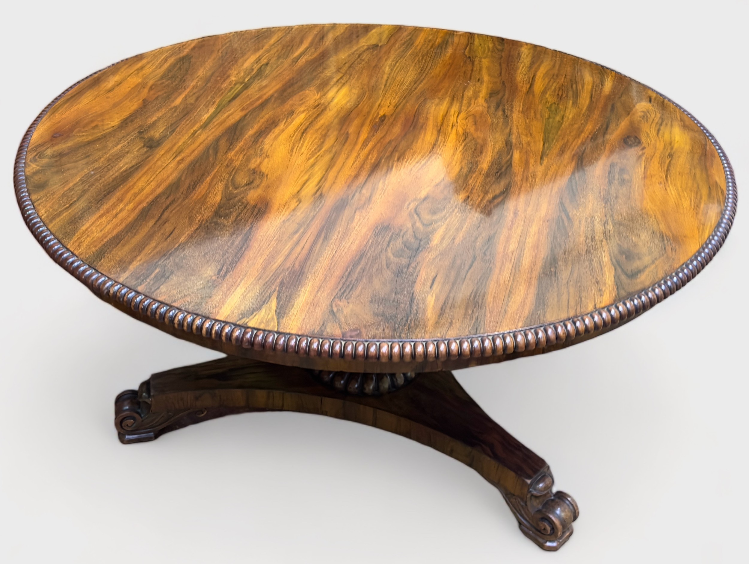 A William IV rosewood breakfast table, the circular tilt-top with beaded edge and brass locking
