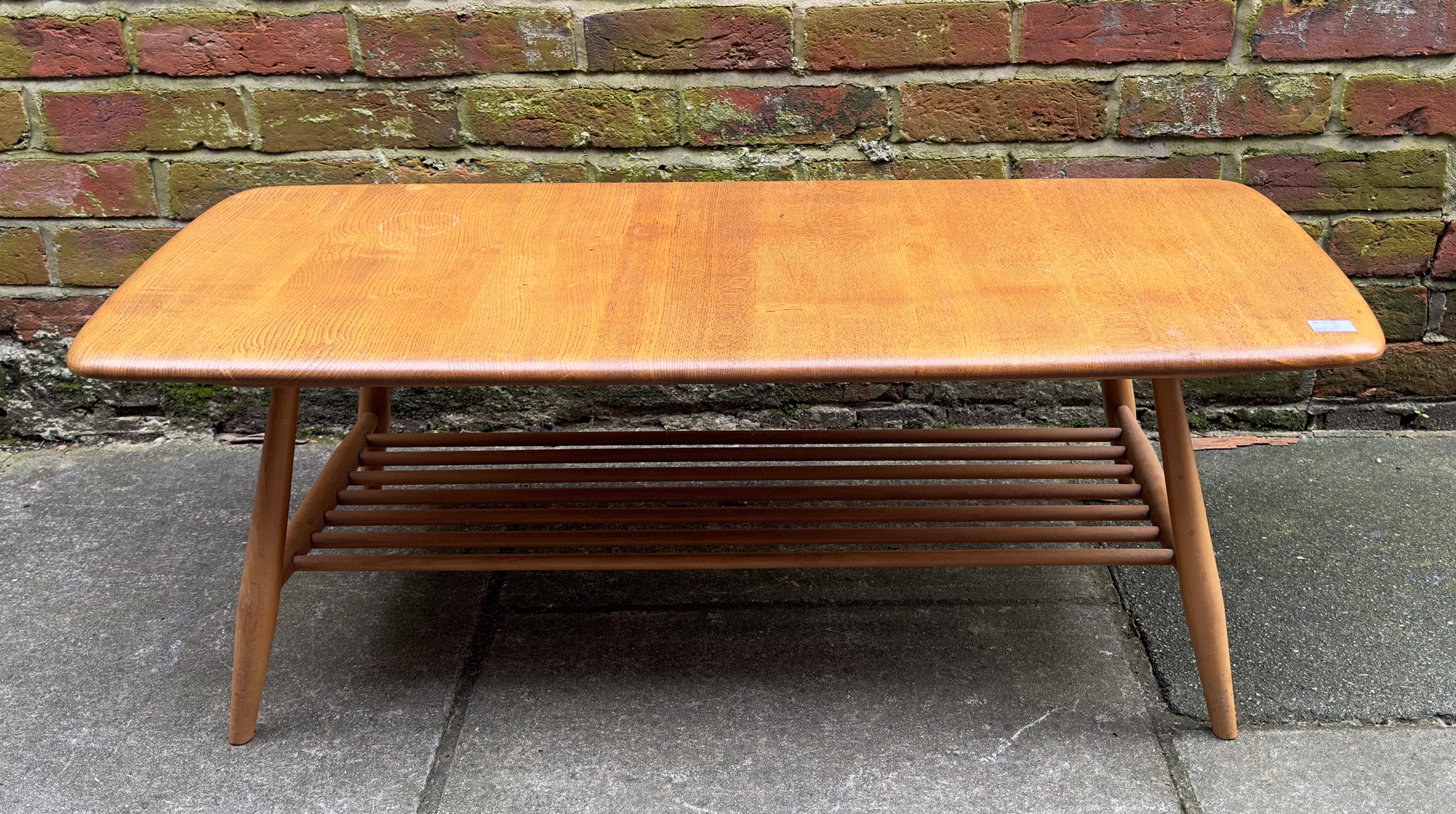 An Ercol blonde elm Windsor low coffee table, model no. 459, of rectangular form, with rounded