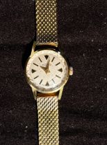 An 18ct gold cased ladies wristwatch by Roamer, the silvered dial with batons denoting hours, on