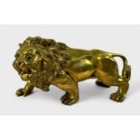 A gilt cast copper alloy figure of a lion, prowling and snarling, 15cm