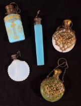 Five various opaque coloured glass perfume bottles including shell-moulded example with etched