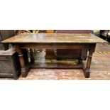 An oak hall/side table, with plank top to plain frieze, raised on turned supports united by