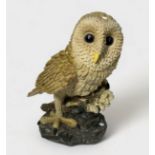 A hand-painted composite moulded figure of a Tawny owl, 30cm high