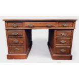 A Victorian mahogany pedestal desk, the red leather scribe above the central frieze drawer flanked