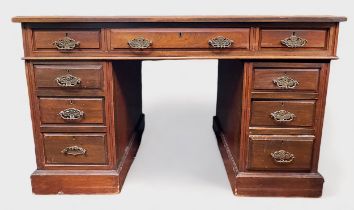 A Victorian mahogany pedestal desk, the red leather scribe above the central frieze drawer flanked