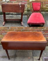 An Edwardian mahogany drop-leaf table, central frieze drawer with drop pull at each end, raised on