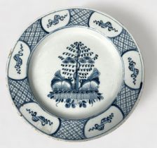 A 19th century Dutch Delft pottery large circular plate, painted in underglaze cobalt blue with