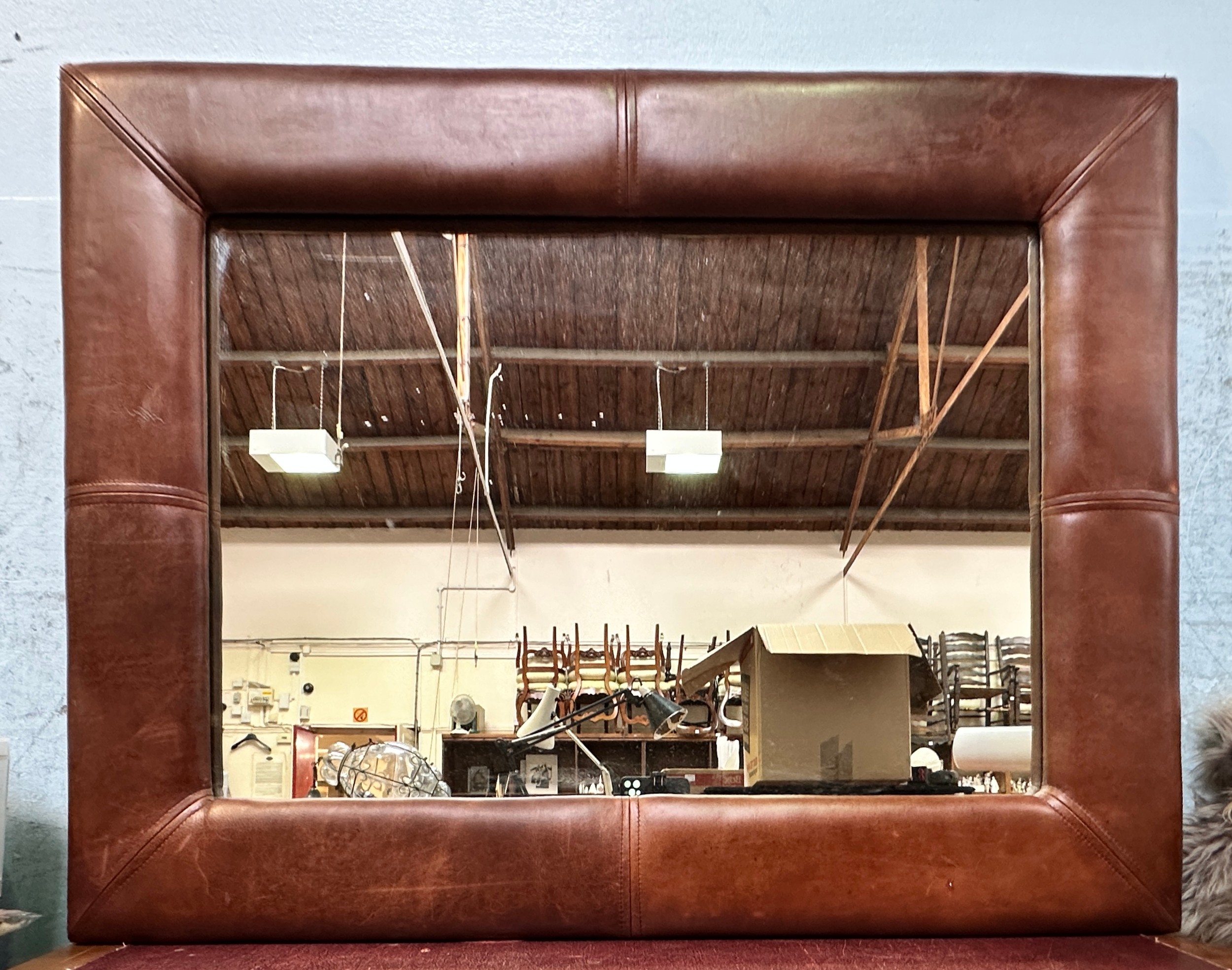 A large modern brown leather framed rectangular mirror, 68cm x 89cm