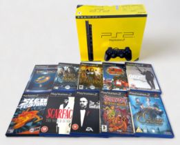 A boxed Sony PlayStation 2, Charcoal Black, with three wired controllers and fifteen various