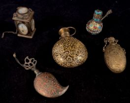 A glass perfume bottle mounted in gilt-metal square section case set with hand-painted panels of