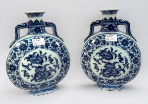 A pair of 20th century Chinese porcelain moon-flasks, of typical form and with blue and white floral