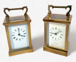 Two brass cased carriage clocks, of near identical form, both with white enamelled dial and Roman