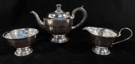 A George V three-piece silver tea set comprising teapot with black compoisite handle, sugar and