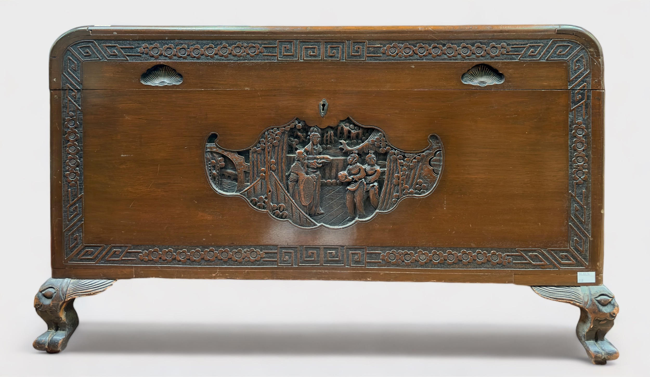 An Oriental carved camphor wood blanket chest, of rectangular form with hinged top, inset carved