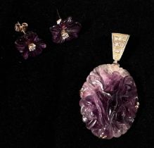 A pair of amethyst and diamond earrings, each carved a five-petal flower, claw-set to the centre