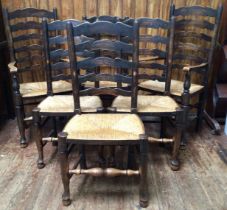 A set of six 19th Century oak and rush seated ladder back dining chairs, raised on tapering legs