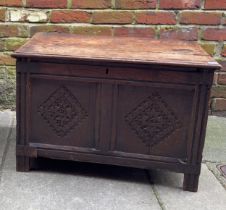 A 17th Century oak coffer, two panel front with ornately carved diamond lozenge, wrought iron