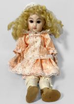 A bisque Bebe doll’s head, bearing stamp for ‘Depose Jumeau’ to back of head, with fixed brown eyes,