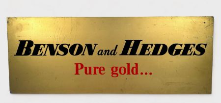 A painted metal Benson and Hedges ‘Pure gold…’ advertising sign, gold coloured ground with black and