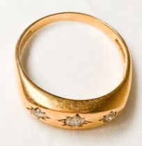 An 18ct yellow gold dress ring, star-set with three Victorian cut diamonds, estimated total weight