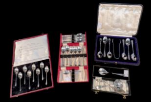 An Edwardian cased set of six coffeespoons and sugar tongs, Sheffield, 1906, a cased set of eight