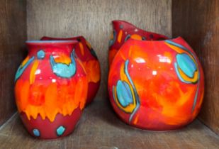 Three various Poole Pottery vases, comprising two large purse vases in the Volcano and Peacock