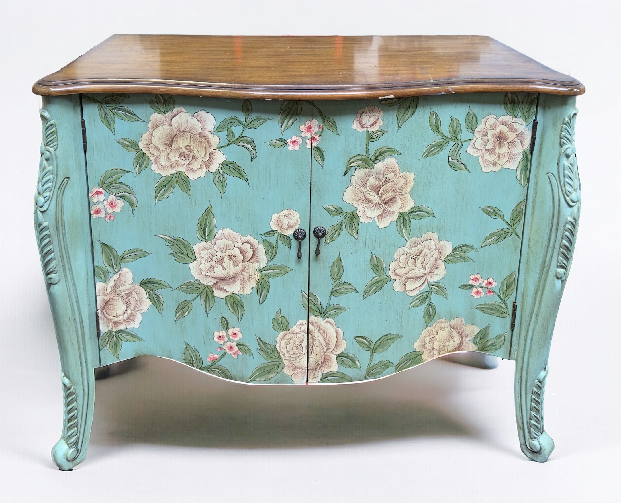 A Continental commode cupboard, of serpentine form, the walnut top above a floral painted aqua