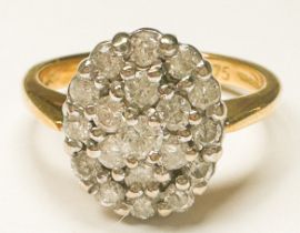 An 18ct yellow gold dress ring, claw set with 19 round brilliant cut diamonds in an oval-shaped